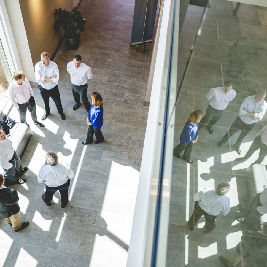 photo looking down onto a group of people in modern building